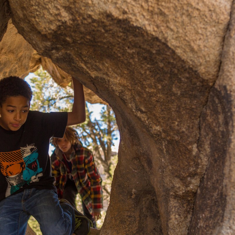 a man riding on top of a rock
