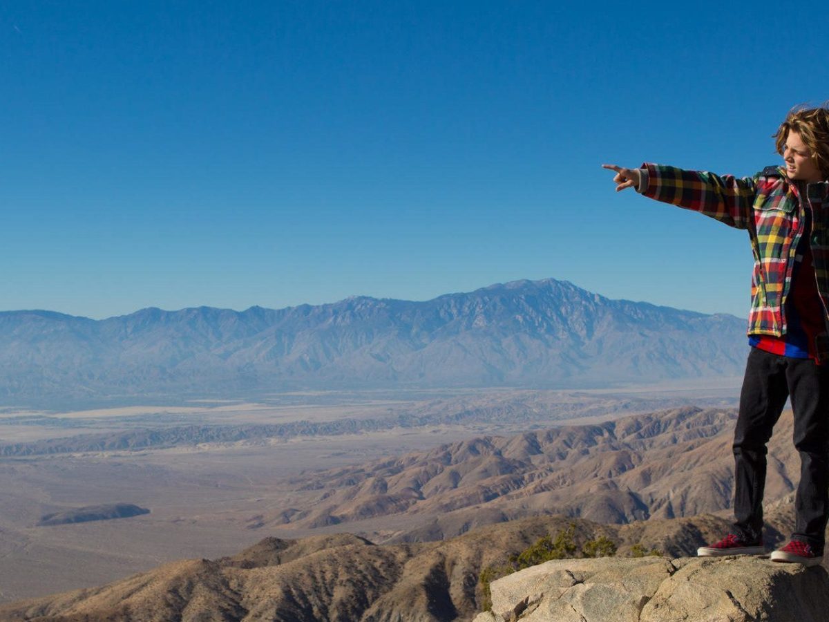a man standing on top of a mountain