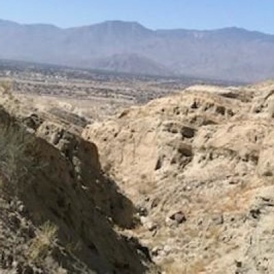 a person standing in front of a mountain